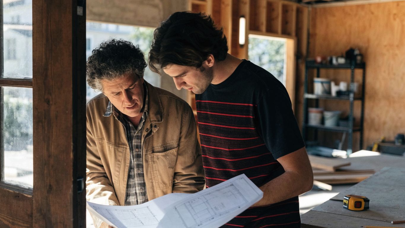 Contractor reviewing garage renovation plans on site